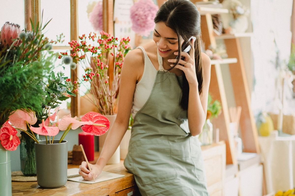 A florist writing down an order on the phone