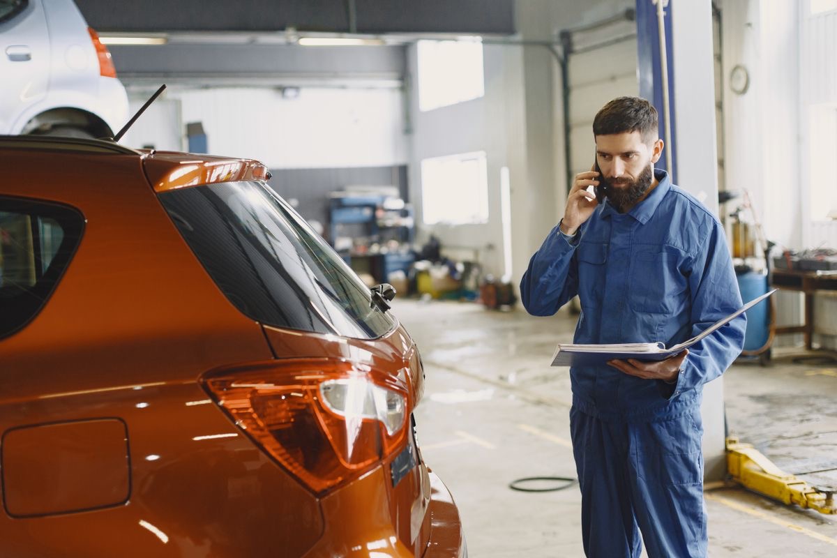 A mechanic taking a call in his workshop
